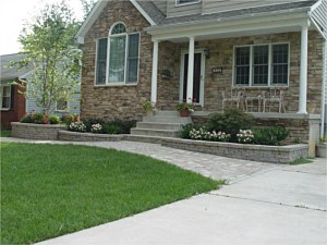 Paver walk with Celtik wall garden boxes, landscaping and stone veneer on front of the house